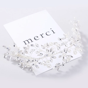 Macro shot of silver bridal headpiece with marquise crystals and white faux pearls