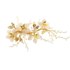 Elegant handmade bridal hairpiece with gold leaves, white silk petals and pearls