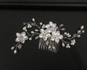 Detailed view of silver wire wedding hair comb with white flowers and pearl crystals