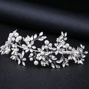 Detailed macro view of handmade bridal hair vine with pearls and marquise crystals