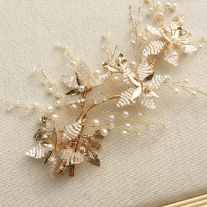 Detailed view of handmade bridal hairpiece with gold wire, white beads and pearls