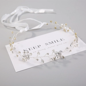 Detail of handmade silver bridal headband with sparkling marquise and round rhinestones