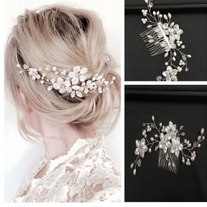 Handmade bridal hair comb featuring white flowers, pearls, and crystals on gold wire