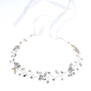 Silver bridal hair vine with sparkling crystals and white ribbons on white background