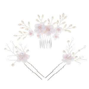 Macro detail of bridal hair set with white flowers, pearls and crystal beads on silver wire