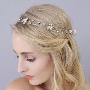 Detail of silver bridal headband with sparkling rhinestones on golden hair