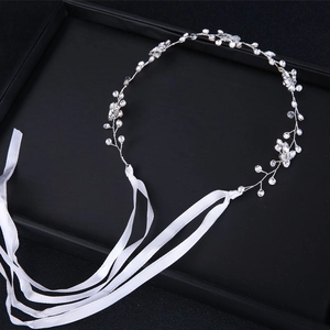 Silver bridal headband with sparkling rhinestones and white ribbons on black display box