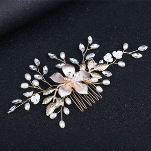 Exquisite golden bridal hair comb with white flowers, pearls, and crystals for weddings