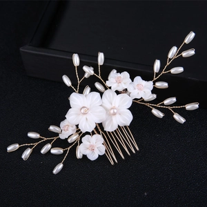 Exquisite bridal hair comb with white flowers and pearls on golden wire floral accessory
