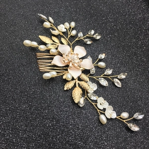 Detail of bridal hair comb with gold wire, pearls, alloy flowers and crystals