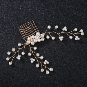 Elegant bridal hair comb with handmade pearls and gold wire branches on black background