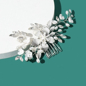 Detailed macro view of handcrafted silver flower bridal hair comb with pearls and crystals