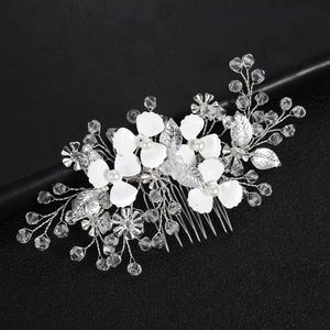 Close-up of handmade bridal hair comb with pearls, crystal beads and silver metal leaves