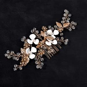 Exquisite bridal hair comb with gold wire, white floral petals and shimmering crystals