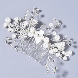 Detail showing bridal hair comb with pearls, sparkling rhinestones and white resin flowers