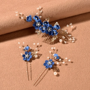 Three-piece bridal hair jewelry set with blue fabric flowers and golden leaf pins