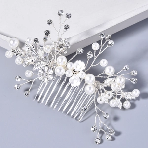 Detailed view of handmade bridal hair comb with pearls, rhinestones and white flowers