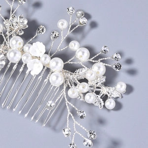 Macro shot of handmade bridal hair comb with pearls, resin flowers and crystals