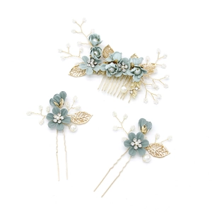 Close-up of bridal hair accessory set with blue silk flowers pearls and crystals