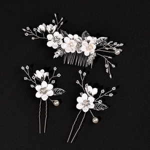 Three-piece bridal hair jewelry set with white fabric flowers and silver metal leaves