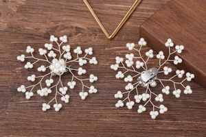 Detail of handcrafted snowflake pearl shoe clips with silver metal alligator backing