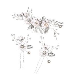 Detail showing white floral hair comb and pin set with pearls and rhinestones