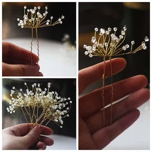 Detailed close-up of handmade gold bridal hair pins with delicate crystal beads for weddings