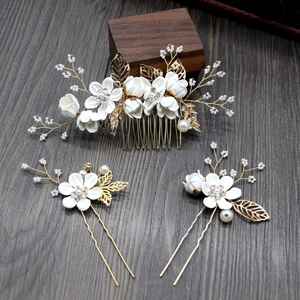 Detailed set of bridal hair pins and comb with white flowers, gold leaves and pearls