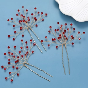 Detailed macro view of three red crystal handmade hair pins with golden U-shaped wire structure