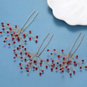 Three red crystal bridal hair pins with golden handmade wire branches on blue backdrop