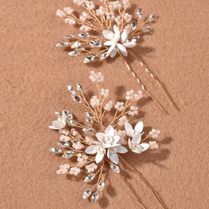 Detail view of handmade gold flower hair pins with pearls and crystals for wedding bridal hair