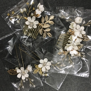 Bridal hair accessories set with white fabric flowers, pearls and rhinestones