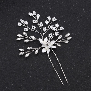 Detailed shot of handmade pearl and marquise rhinestone floral U-shaped bridal hair pin