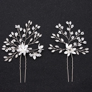 Detail of two handmade bridal hair pins with white flower pearls and silver wire branches