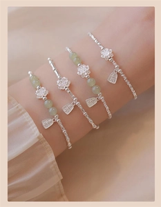 Detailed view of S925 silver bamboo bracelets with jade beads and vintage charms