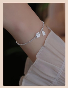 Detail of S925 silver bamboo-style bracelet with flower pendant and Ping An tag