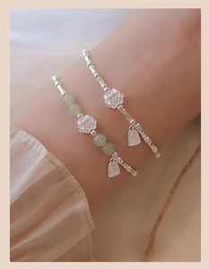 Detail of S925 silver bamboo bracelet with jade beads and carved lotus charm pendant