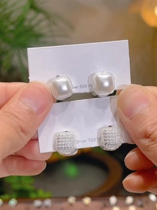 Detail of square pearl and pave cubic zirconia earrings with 925 silver posts