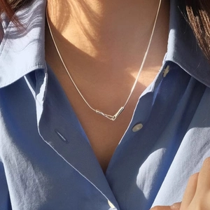 Minimalist geometric sterling silver snake chain necklace with a sleek V-shaped pendant