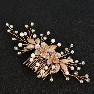 Exquisite bridal hair comb with gold leaves, white pearls and sparkling rhinestones for weddings