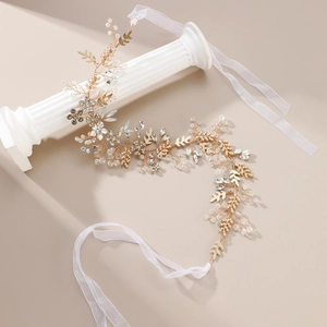 Elegant bridal hair vine with gold leaves and sparkling crystals on silk ribbons