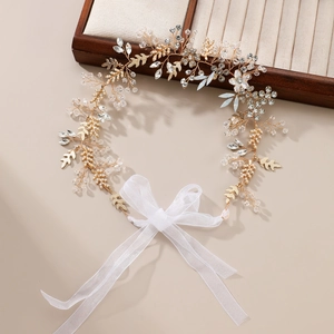 Elegant bridal hair vine with crystal pearls and gold leaf accents on ribbon