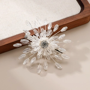 Exquisite bridal crystal flower hair clip with rhinestone center on wooden tray