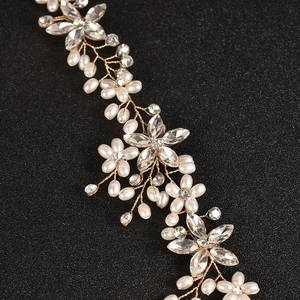 Handmade bridal headband with white pearls and sparkling rhinestones on golden wire