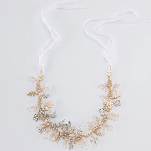 Elegant bridal headband with gold leaves, crystals and pearls for wedding hair styling