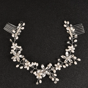 Detailed shot of handmade pearl and crystal flower bridal hair comb with silver wire