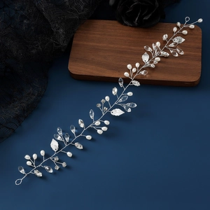 Elegant bridal hair vine with pearls, crystals and silver leaves on a dark luxury background