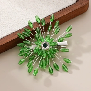 Detailed view of handmade green crystal flower hair clip with silver wire and rhinestones