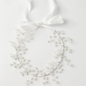 Elegant bridal hair vine with white pearls and silver wire, featuring a satin ribbon tie