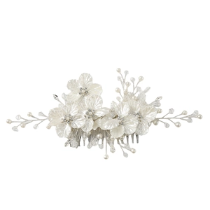 Detailed close-up of handmade bridal hair comb with shell petals, pearls and crystals